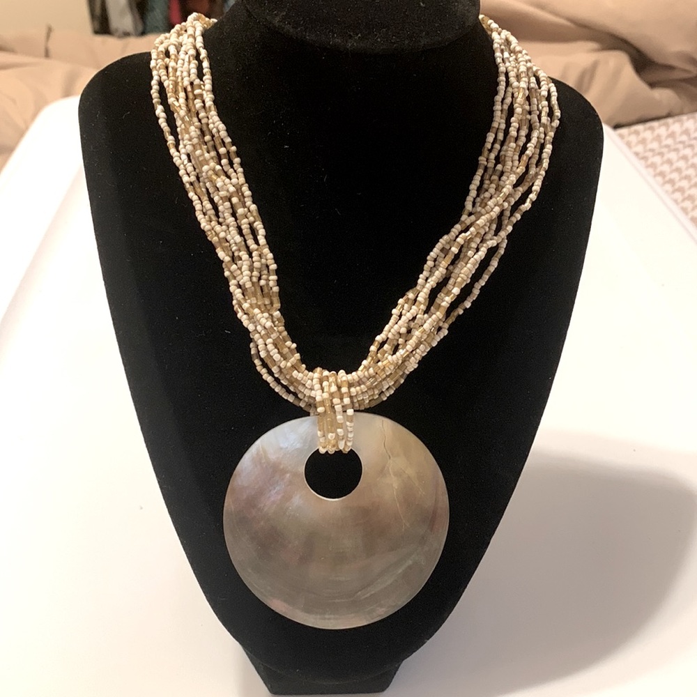 Boho bead necklace with iridescent seashell.